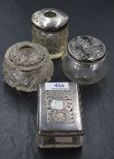 A group of four silver-topped glass dressing table wares, to include two hair tidies, silver