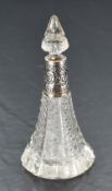 An Edwardian cut glass perfume bottle of conical form having cut glass stopper and moulded silver