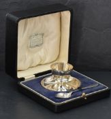 A cased egg cup and spoon of plain circular form, Birmingham 1921, George Unite, approx 81g