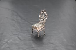 A small Victorian silver salon chair having embossed cherubic decoration, London 1897, Edward