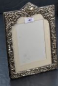 An Edwardian silver photograph frame having extensive cut decoration, plain cartouche and purple