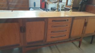 A mid 20th century G-Plan teak sideboard with a rectangular top above a bank of four drawers
