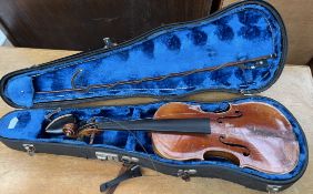 A violin, with a two piece back and ebonised stringing, bears a label for 