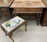 An oak side table with a rectangular planked top above a single drawers on ring turned legs