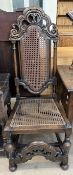 A 17th century style oak chair, with a pierced scrolling top with a caned panel,