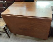 A 19th century mahogany gateleg dining table with a rectangular top and drop flaps on square legs