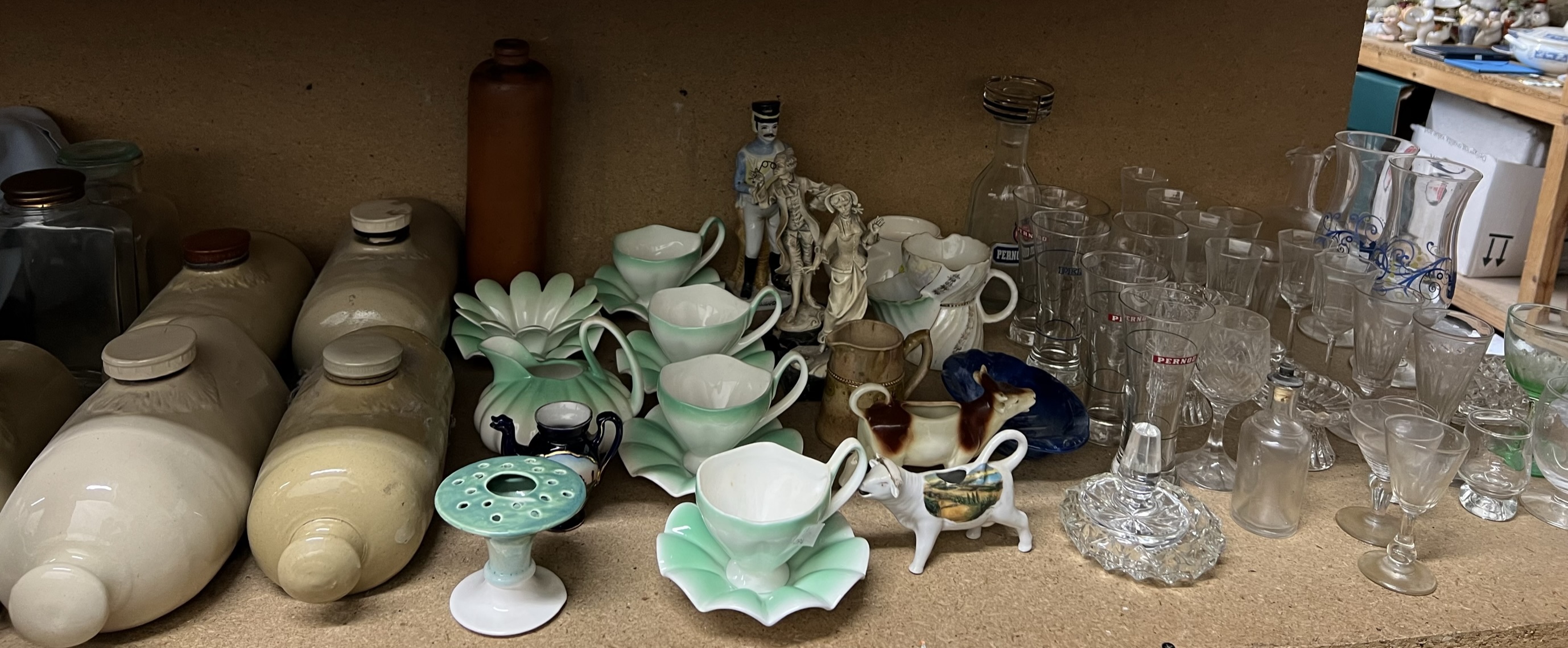 Stoneware foot warmers together with a leaf decorated part tea set, drinking glasses,