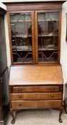 A 20th century mahogany bureau bookcase on cabriole legs with claw and ball feet,
