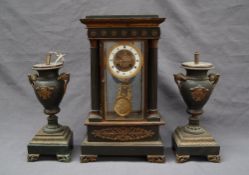 A late 19th century French four glass clock garniture, of architectural form,