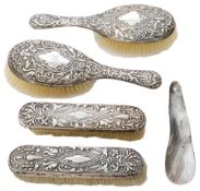 A late Victorian silver backed four piece dressing table set