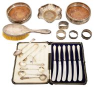 A pair of modern silver bottle coasters and other silver