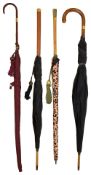 A collection of four umbrellas and parasols