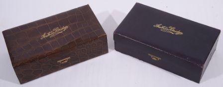 A crocodile leather bridge case and a blue morroco bridge case