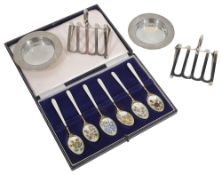 A pair of George V Asprey silver toast racks and pin dishes,