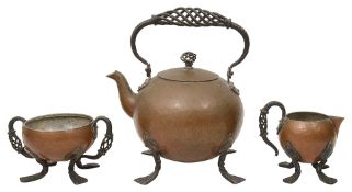 An Arts & Crafts plannished copper and wrought iron three piece tea service