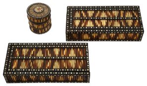 A pair of porcupine quill boxes together with a round example