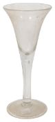 A large Georgian style drawn trumpet shaped plain stem glass goblet