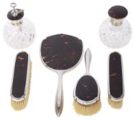 A George V silver and tortoiseshell six piece dressing table set
