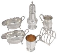 A collection of silver to include a pair of sauce boats, two christening mug and a toast rack