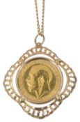 A George V full sovereign on a 9ct gold mount and chain