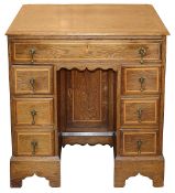 A George II oak and fruitwood crossbanded kneehole desk