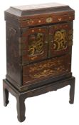 A Japanese Meiji period gilt decorated lacquer kodansu or table cabinet on stand