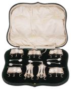 An Edwardian cased Art Nouveau silver seven piece cruet set