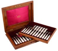 A George V oak cased set of twelve mother of pearl handled fruit knives and forks
