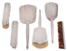 A George VI Art Deco engine turned six piece dressing table set