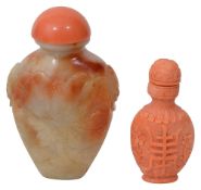 A Chinese carved coral snuff bottle and stopper and a russet celadon jade snuff bottle and stopper