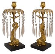 A pair of late Regency gilt bronze dolphin lustre candlesticks c.1830