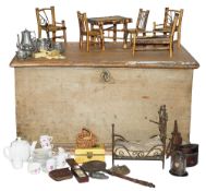A 19th century trunk with 19th century and later dolls house furniture and accessories