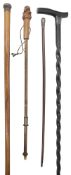 An Edwardian ebony walking stick with three others