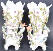 SITZENDORF PAIR OF FLORAL ENCRUSTED CHERUB VASES