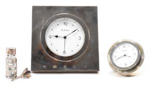 TWO SILVER FRANTED R J CARR CLOCKS & SILVER COLLARED SCENT BOTTLE