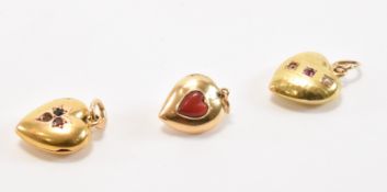 THREE ANTIQUE GOLD GEM SET HEART PENDANTS