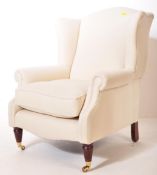 CONTEMPORARY CREAM UPHOLSTERED WINGBACK ARMCHAIR