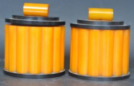 PAIR OF EARLY 20TH CENTURY CIRCA 1930S ORANGE BAKELITE JARS