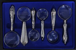 SIX WHITE METAL MAGNIFYING GLASSES