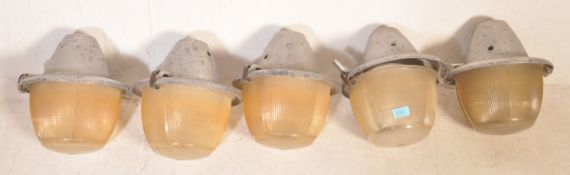 A collection of retro vintage mid 20th century industrial factory lights having a metal circular