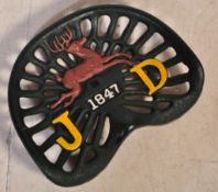 A 20TH CENTURY CAST IRON JOHN DEERE PIERCED TRACTOR SEAT