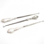 THREE ANTIQUE SILVER HANDLED BUTTON HOOKS