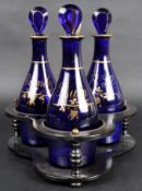 19TH CENTURY BRISTOL BLUE DECANTERS ON PAPIER MACHE STAND