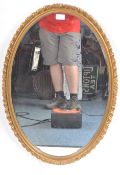 VINTAGE HOLLYWOOD REGENCY GILT FRAMED OVAL MIRROR