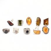 GROUP OF TEN SILVER & WHITE METAL RINGS - AMBER