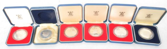 SIX SILVER PROOF COMMEMORATIVE CROWN COINS