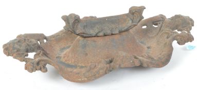 A RETRO VINTAGE GREEN MASK MAN CAST IRON BOOT SCRAPER