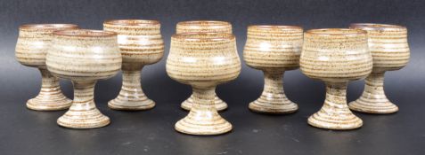 MATCHING SET OF EIGHT STUDIO ART POTTERY GOBLETS
