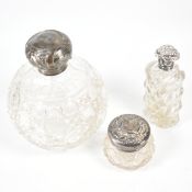 THREE ANTIQUE SILVER TOPPED BOTTLES