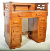1920's oak Arts & Crafts twin pedestal desk having pierced gallery surround top with leather inset